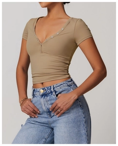 Close-up of khaki slim fit yoga t-shirt featuring deep V-neck and button detailing