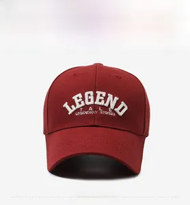 Close-up of white 3D embroidery on burgundy baseball cap with Legend Tale text detail