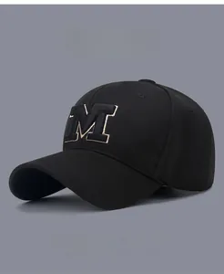 Detail of embroidered M letter on black mesh baseball cap with contrast trim
