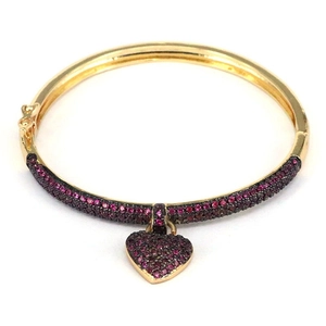 Adjustable gold heart bangle with pavé pink zircon stones on minimalist background