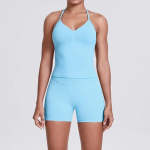 Front view of seamless high-waist light blue yoga set with halter v-neck top and shorts
