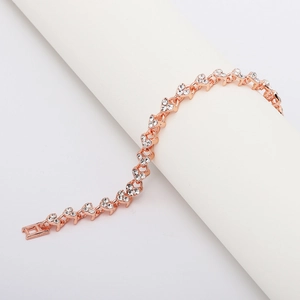 Close-up of rose gold heart-shaped bracelet links with sparkling white zircon inlays