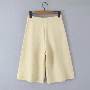 Detailed vertical rib texture of beige knitted wide-leg shorts with elastic waist