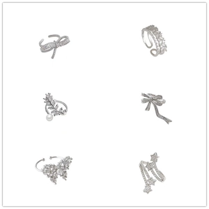Set of six silver adjustable zircon rings featuring butterfly, pearl, and star designs