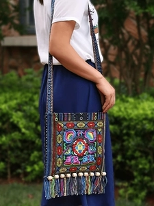 Ethnic bohemian crossbody bag with colorful floral embroidery and tassel details