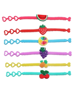 Detail of colorful fruit-themed silicone bracelets with heart clasps for kids party