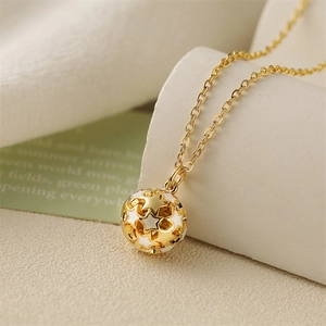 Detailed close-up of hollow star pendant necklace with gold chain on soft background