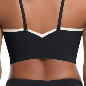 Close-up of V-back seamless sports bra with black and beige dual-tone patchwork design
