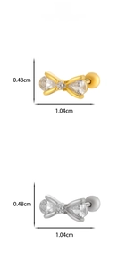 Detail of titanium steel bow earrings with zircon stones in gold and silver finishes
