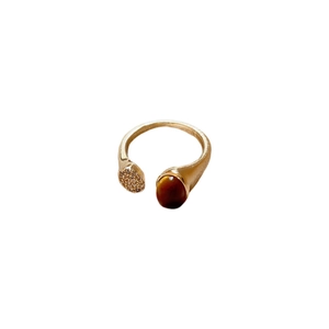 Adjustable golden ring featuring a tiger eye stone and shimmering cubic zirconia pave