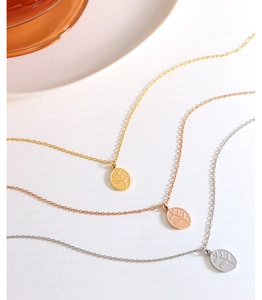 Detailed view of leaf pendant necklaces in gold, rose gold and silver finishes