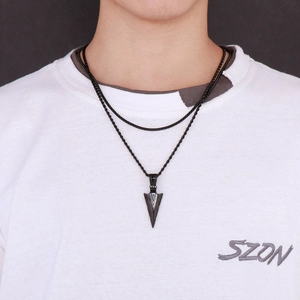 Detail of a black double-layered stainless steel necklace featuring a sharp arrow pendant