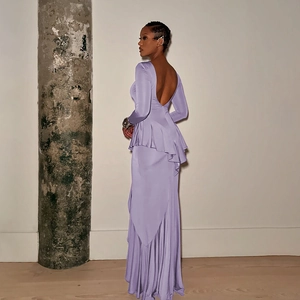 Detail of a backless purple maxi dress with waist ruffles and elegant slit