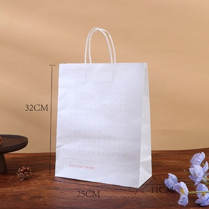 White paper gift bag with pink dots and elha laser center logo showing 32x25x11cm dimensions