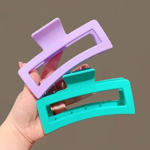Close-up of 13cm matte square hair claws in lavender and teal for thick hair styles
