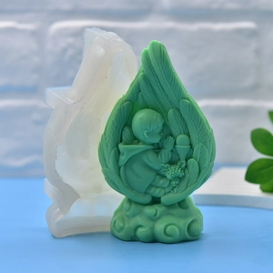 DIY silicone mold featuring a detailed praying baby angel statue in a feather leaf cocoon