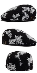 Detail view of cotton jacquard beret showing vintage floral pattern and metal buckles