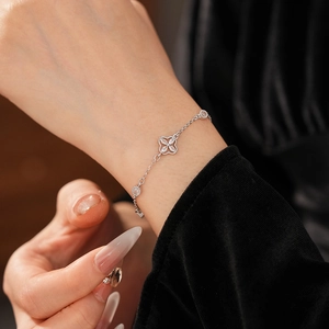 Detail of adjustable silver flower bracelet with sparkling cubic zirconia on wrist
