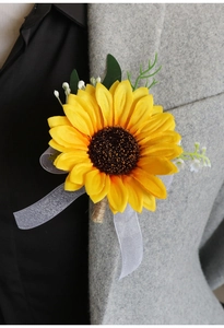 Close-up of artificial sunflower boutonniere with baby's breath on a grey suit lapel
