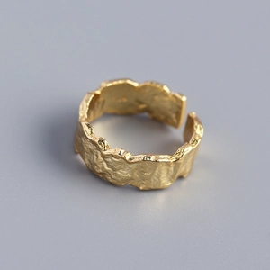 Macro shot of S925 sterling silver ring with irregular gold foil lava texture and open band