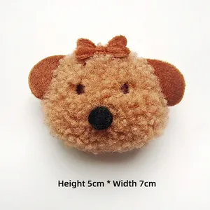 Detail of plush teddy dog accessory with bow tie, measuring 5cm high and 7cm wide