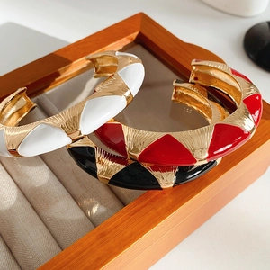 Close-up of French vintage open bangles with colorful enamel inlay in luxury gift box
