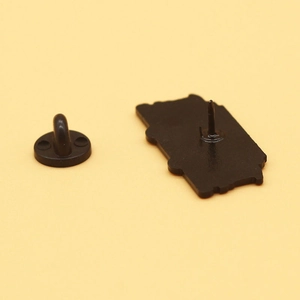 Detail view of the metal enamel pin back with a black rubber butterfly clutch fastener