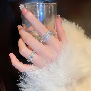 Elegant silver layered ring set featuring sparkling cubic zirconia and white pearls on model