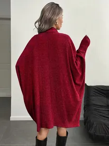Detail view of the deep red ribbed knit texture and batwing sleeves on an oversized dress
