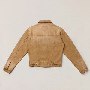 Detailed back view of vintage yellow denim jacket with distressed texture and metal buttons