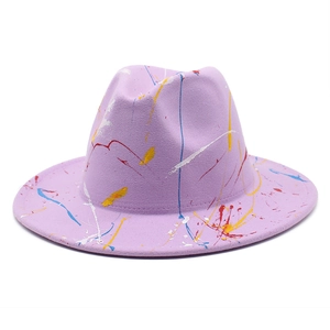 Close-up of artistic paint splatter texture on light purple wool felt fedora hat