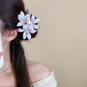 Detailed view of light purple lily flower hair clip with realistic water droplets on petals