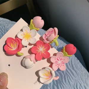 Close-up of 8 pieces pink cherry blossom resin hair clips on card for women