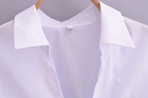 Gros plan d'un chemisier blanc style fille douce avec col à revers classique et volants