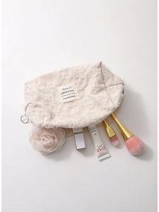 Lace-embroidered corduroy makeup bag in beige, showing open storage for brushes and skincare