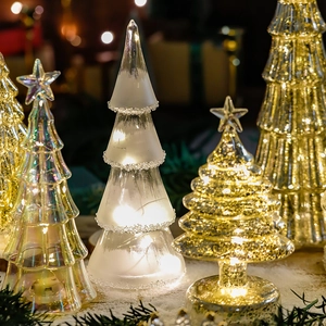 Lighted glass Christmas tree ornaments in frosted white, clear, and gold for festive decor