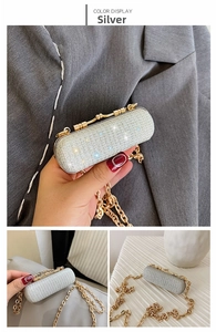 Detail of silver sequined mini evening bag featuring gold chain and retro clasp