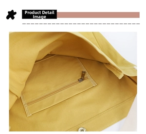 Detail view of bright yellow canvas tote bag showing inner zipper pocket and magnetic snap