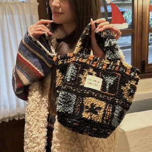 Close-up of plush patchwork tote bag showing colorful fleece texture and fabric label