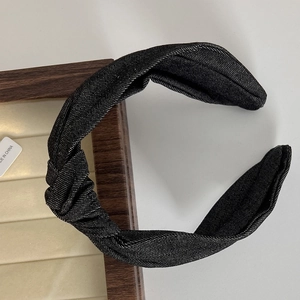 Detailed close-up of dark grey denim knotted headband texture and fabric craftsmanship
