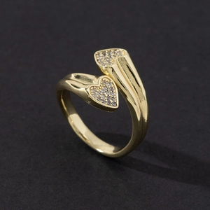 Macro shot of gold-plated open ring with heart-shaped white zircon paving and sleek finish