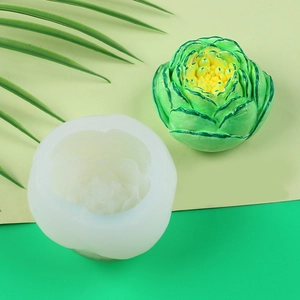 Detailed view of translucent silicone peony flower mold and a green finished candle art