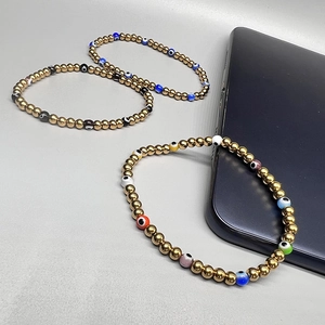 Detailed shot of three 18K gold plated beaded bracelets with colorful evil eye beads