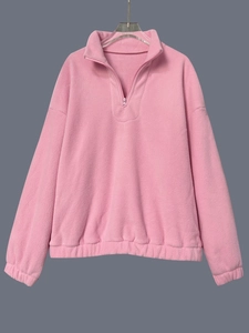 Detail of pink fleece sweatshirt with half-zip design and soft textured fabric finish