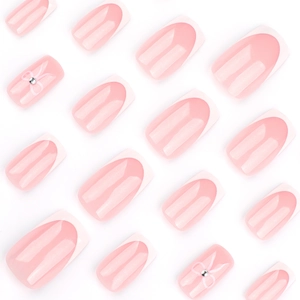 French tip press-on nails with pink base, white bows and rhinestones in square shape