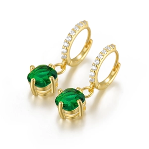 Detail of S925 silver earrings with green cushion-cut gems and micro-pave zircons