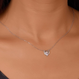 Close-up of heart pendant with pink zircon cat paw inlay on sterling silver chain