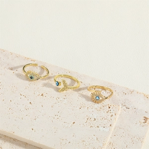 Adjustable gold-tone rings featuring evil eye, mermaid tail, and pearl accents