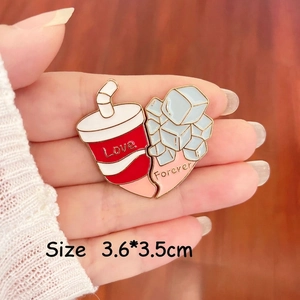 Detailed close-up of heart-shaped Love and Forever enamel pins held by hand