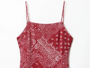 Detail of red paisley print summer dress with thin straps and square neckline
